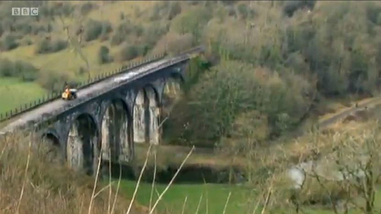 Construction traffic emerges from the Headstock tunnel onto the Monsal Viaduct in Monsal Dale
