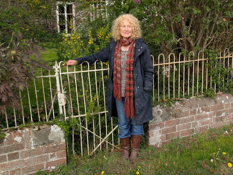 Julie Neubert at the gate of the Cohen family cottage from Starvation, April 13 2025