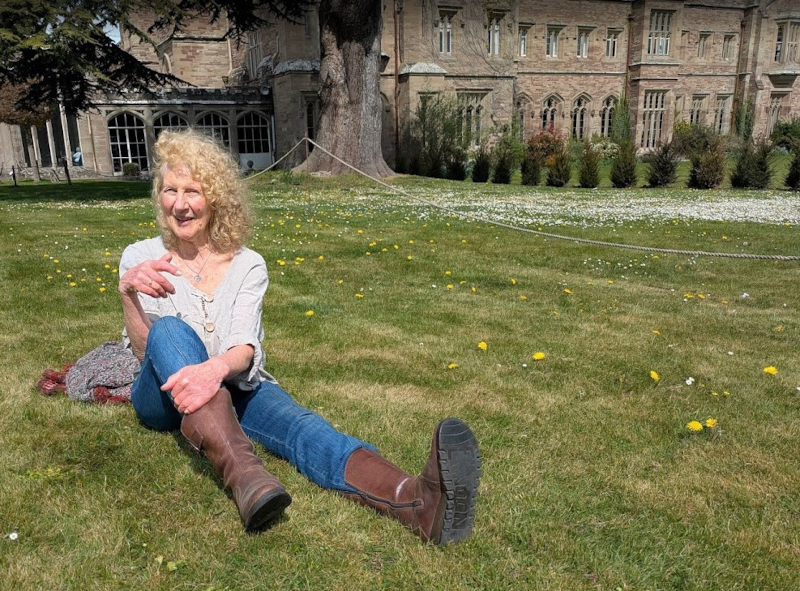 Julie Neubert relaxing in the ground ofHampton Court Castle, Herefordshire on 13 April 2025